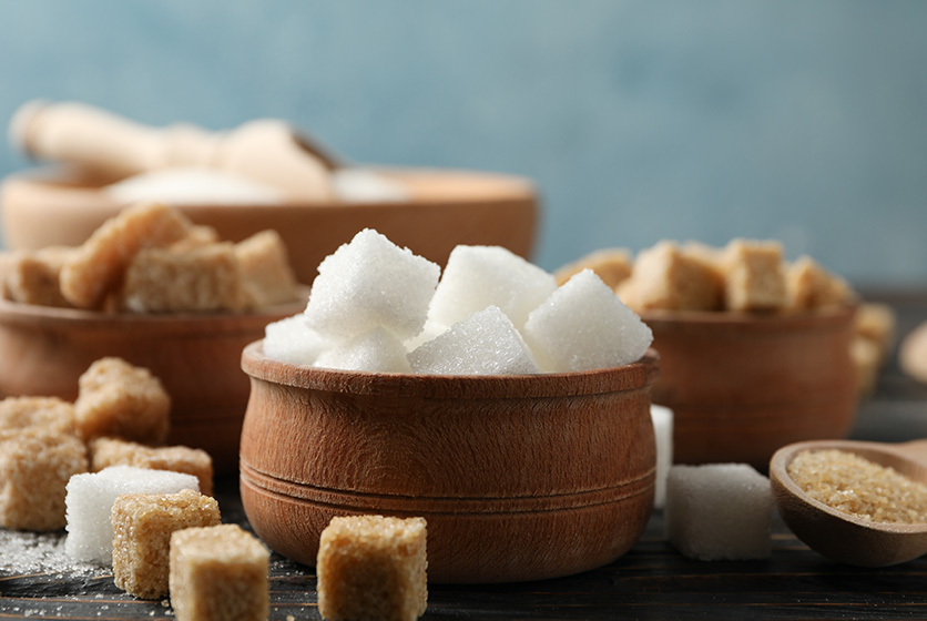 Wooden bowls filled with different types of sugar cubes